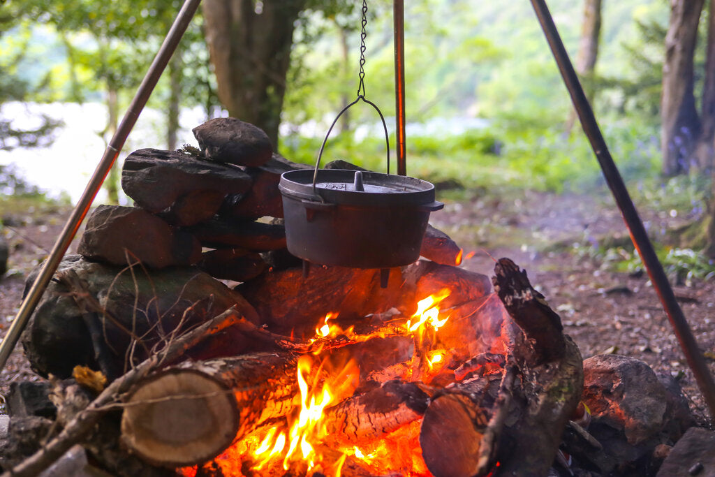 Cooking over a camp fire, with cast iron pots and coffee pot